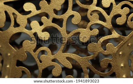 Abstract shaped texture made of brass. Brass ornament