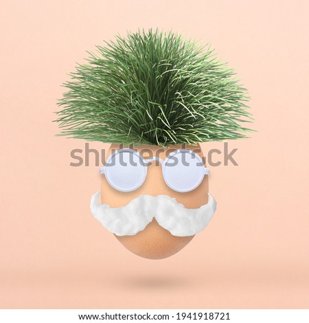 Fluffy creative Easter egg made of green grass, sunglasses and mustache on pastel pink background. Minimal spring concept. Flat lay. Royalty-Free Stock Photo #1941918721