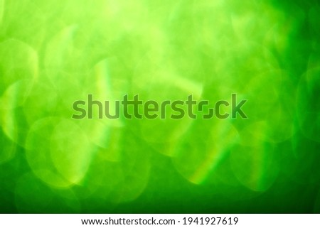Abstract green background, light and shadows, reflections and bokeh