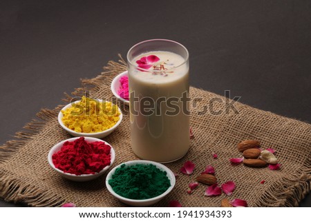 Indian festival Holi concept - Traditional Indian beverage Thandai Sardai milk festival food, with nuts and color in bowl. Royalty-Free Stock Photo #1941934393