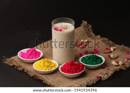Indian festival Holi concept - Traditional Indian beverage Thandai Sardai milk festival food, with nuts and color in bowl. Royalty-Free Stock Photo #1941934396