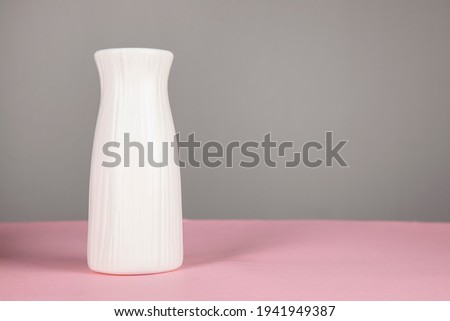 empty white vase on pink table background