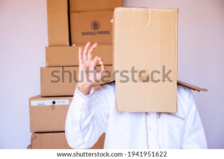 arabic man putting carton box on his head