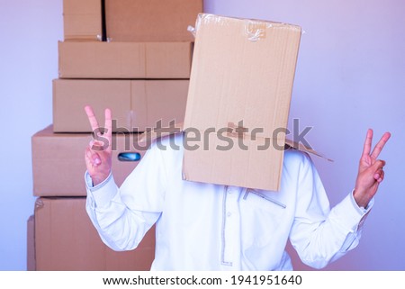 arabic man putting carton box on his head