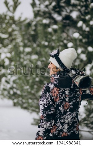 Woman skiing at ski resort wearing equipment