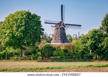 Looking towards the famous Dutch windmill called the 'Bollwerksmill' located near the river IJssel and the Hanze city of Deventer. It is a sawmill and is built in the year 1863. Royalty-Free Stock Photo #1941988807