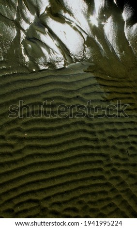 the texture of the sand on the beach