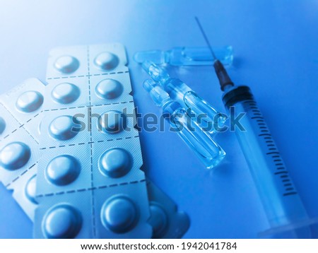 Medical syringe, ampoules and pills stock photo