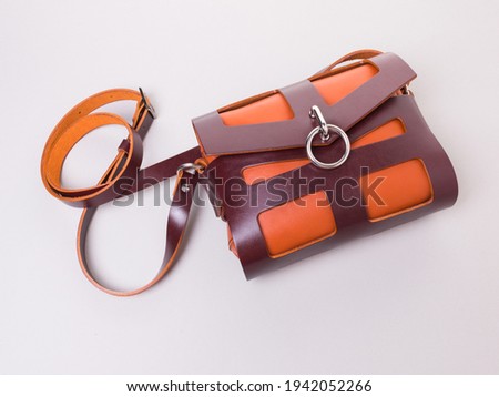 Genuine leather crossbody bag. Model for woman. Orange and brown colors