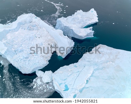 aerial view of arctic icebergs in greenland, broken glaciers.