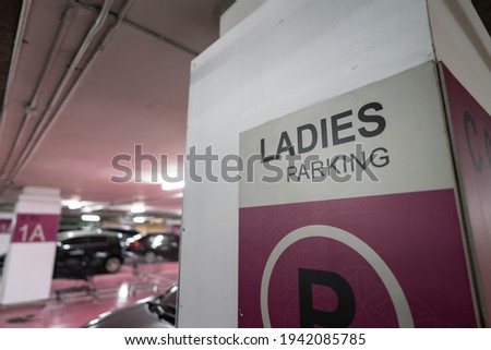 "Lady Parking" area sign inside the car parking lot of office or commercial mall building. Transportation object symbol photo.
