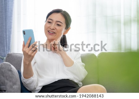 Middle-aged Asian woman in the living room
