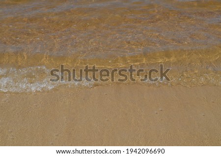 Picture of little waves and sand.