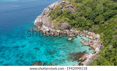 Aerial drone view of boats around the tree covered island of Ko Similan in Thailand 2021
