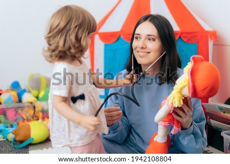 Cheerful Mother with Stethoscope and Doll Playing Doctor. Mom and daughter learning and playing educational game
 Royalty-Free Stock Photo #1942108804