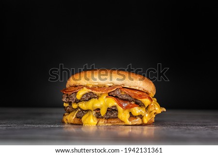 smash burger  with american cheese and peperoni Royalty-Free Stock Photo #1942131361