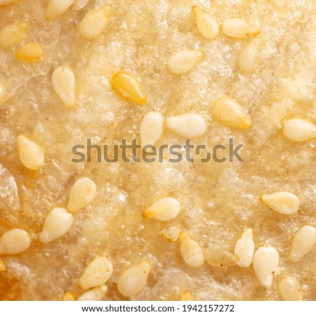 Sesame seeds on a crust of bread as a background. Close-up
