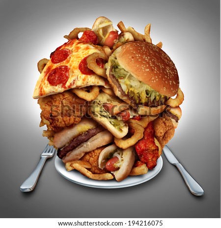 Fast food diet concept served on a plate of greasy fried take out as onion rings burger and hot dogs with fried chicken french fries and pizza as a symbol of compulsive overeating and dieting. Royalty-Free Stock Photo #194216075