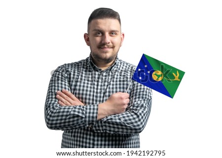 White guy holding a flag of Christmas Island smiling confident with crossed arms isolated on a white background.
