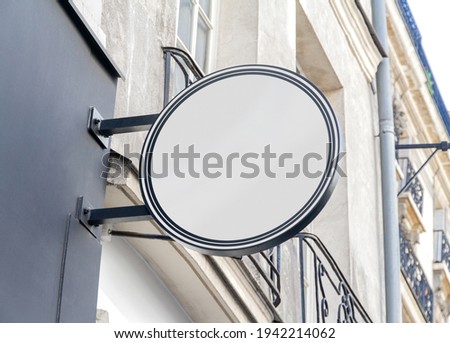 Circular store brand sign board mockup. Empty rounded shop frontage in street