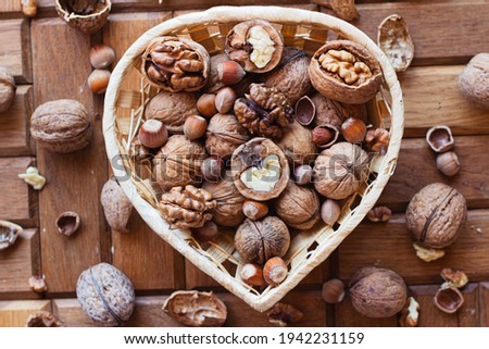 chopped nuts in a heart-shaped basket. nearby lies the nutcracker.
