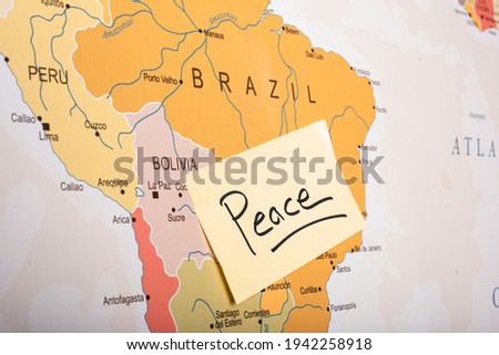 peace written on a sticky note attached with the Brazil country on world map