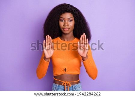 Portrait of attractive serious strict wavy-haired girl showing palms stop isolated over violet purple pastel color background