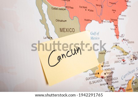 
Cancun written on a sticky note attached with the Mexico country on world map