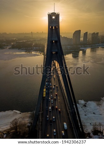 North bridge in Kiev at sunset. Aerial drone view. Spring evening, the sun's rays pass through the pillars of the bridge.