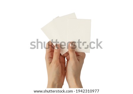 Hands of young woman with golden nail polish holding three blank business cards mockup, stationery template isolated on white background. Royalty-Free Stock Photo #1942310977