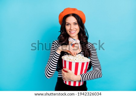 Photo of charming lady hands hold popcorn have good mood look camera isolated on blue color background