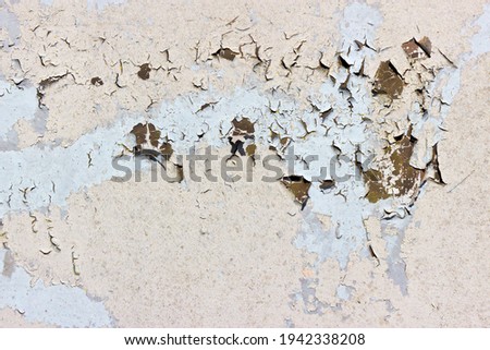 Detail of peeling, cracked and flakey paint on a metal surface Royalty-Free Stock Photo #1942338208