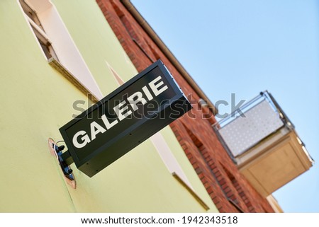 Sign of a gallery on building as an advertisement for art trade in the city