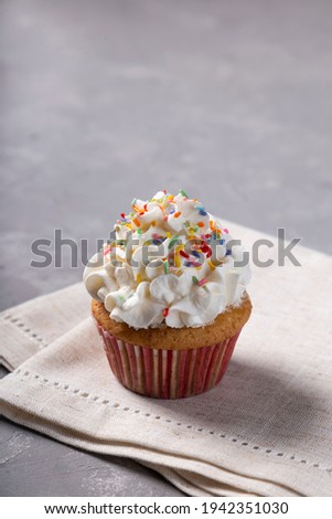 Tasty party cupcakes on the table. Cupcakes with whipped cream.