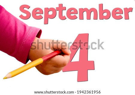 Children's hand writes September 4 in red pencil on white background. Business and leisure concept