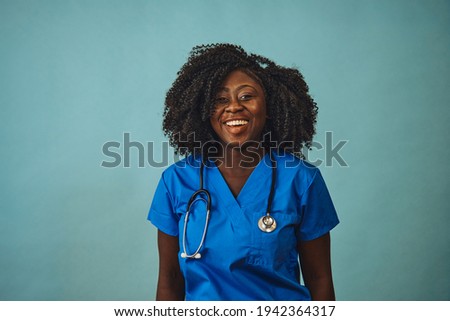 woman doctor smiling with stethoscope looking front Royalty-Free Stock Photo #1942364317