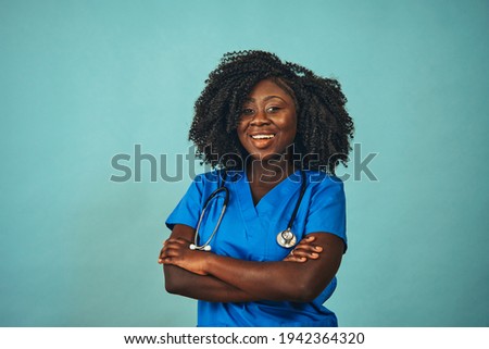 Female doctor smiling with arms crossed looking ahead