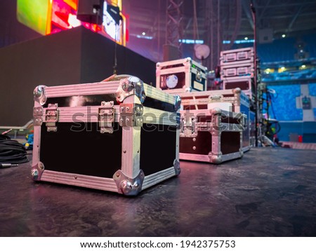 Preparation for concert concept. Cases for musical equipment on stage. Sound equipment transport boxes. Concept - rental of sound equipment. Rent and sale of musical instruments. Concert facilities Royalty-Free Stock Photo #1942375753