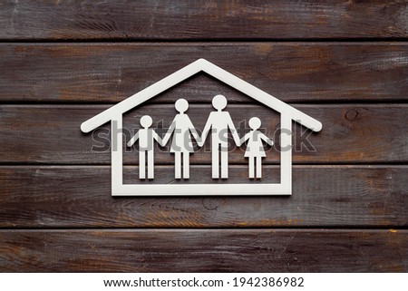 Wooden family figure in house. Stay at home concept
