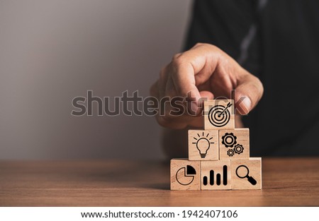 Businessman putting target board on others icons for setup business achievement objective target.