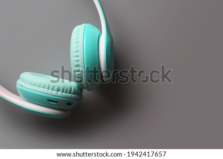 Professional wireless headphones isolated on gray background	

