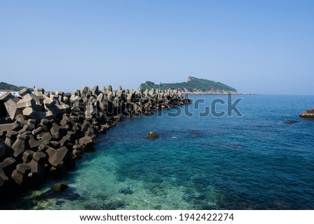 Chopping block coastline with clear blue sea.
