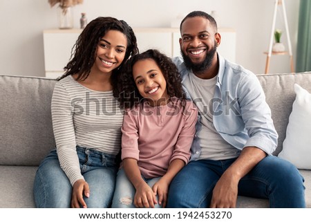 Portrait of a happy black family smiling at home