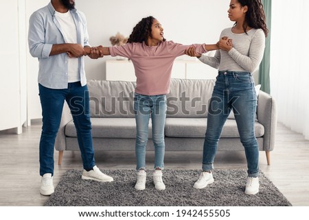 Divorce. Angry black parents fighting over their child Royalty-Free Stock Photo #1942455505