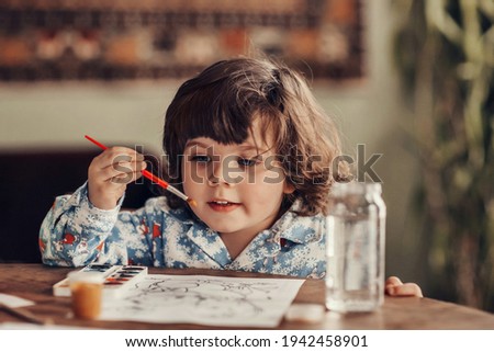 The boy draws a picture