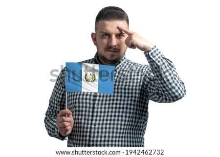 White guy holding a flag of Guatemala and a finger touches the temple on the head isolated on a white background.
