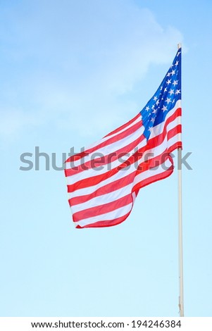 American flag on a post with cloudy background