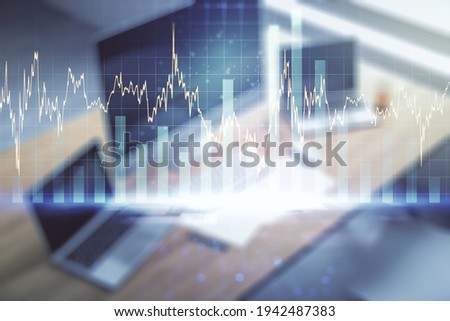Double exposure of abstract creative financial chart and modern desktop with laptop on background, research and strategy concept