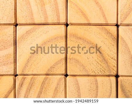 Background with wooden cubes together forming a wall in full size of the image. Close up photo and flat view. Texture photo for background or graphic resources.
