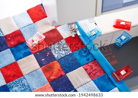 Making of quilt binding by dint of sewing quilting clips by using sewing machine Royalty-Free Stock Photo #1942498633